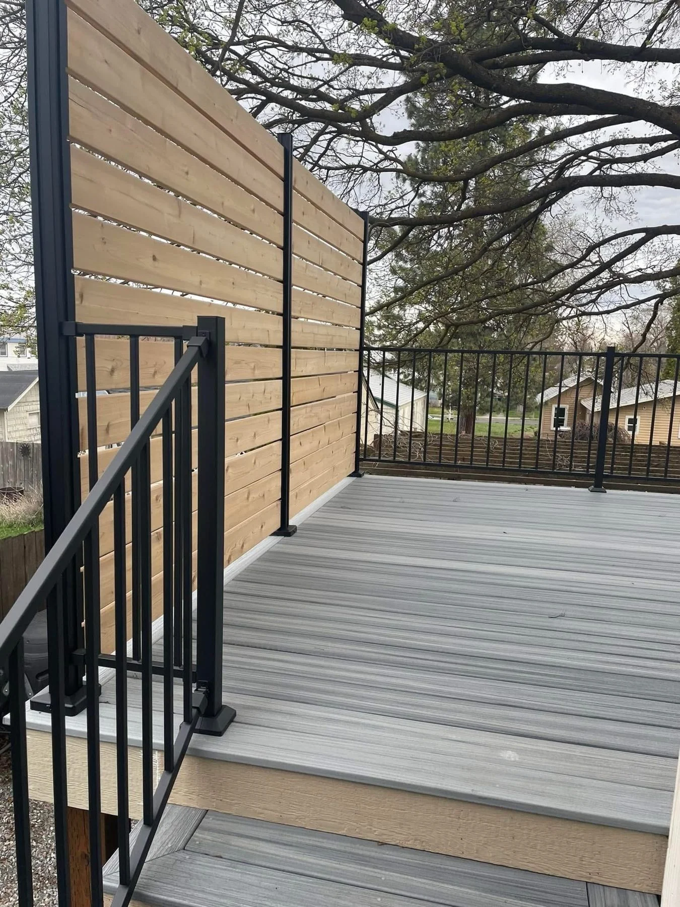 A beautiful, durable composite deck with modern black railings.