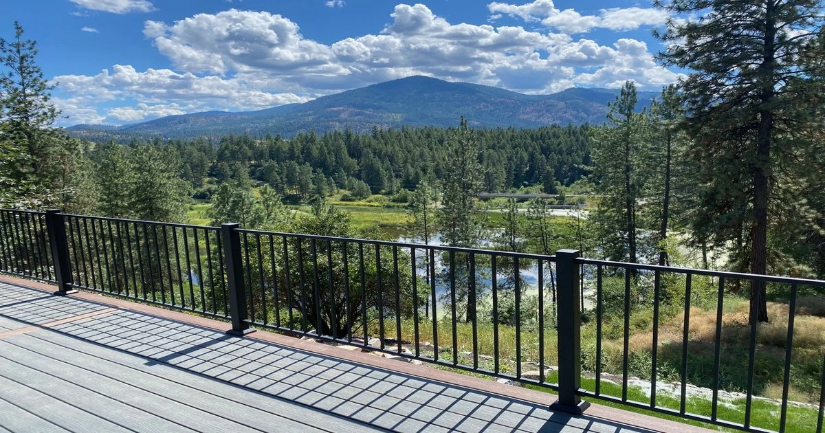 A stunning view from a newly built deck overlooking a river and forested hills in the Inland Northwest.